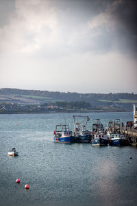 Boats sailing in calm sea against sky