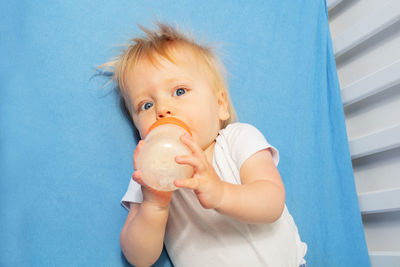 Portrait of cute baby boy with daughter at home