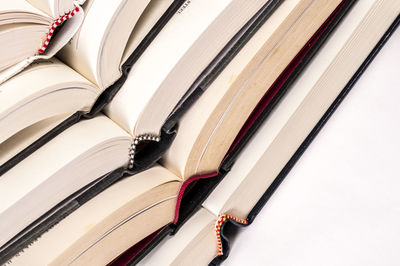 Close-up of stacked books on white table