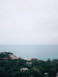 High angle view of buildings and sea against sky