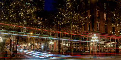 Light trails on road in city at night