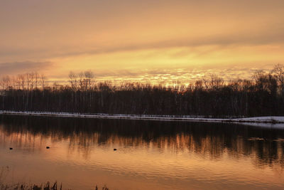 Scenic view of lake against orange sky