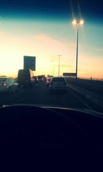 Cars on road at sunset