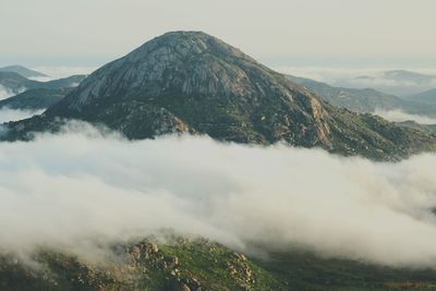 Scenic view of mountains against cloudy sky