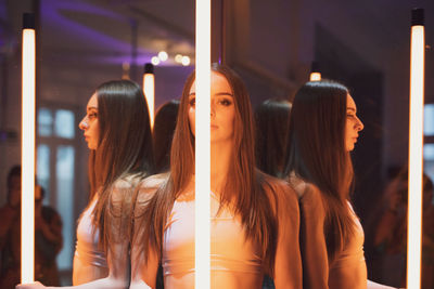 Rear view of woman looking through window