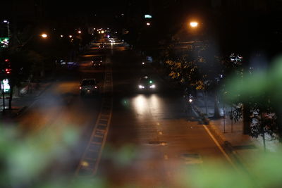 Illuminated city street at night