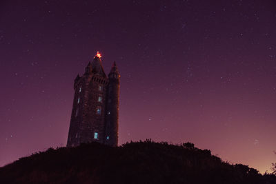 Low angle view of scrabo tower against sky at night