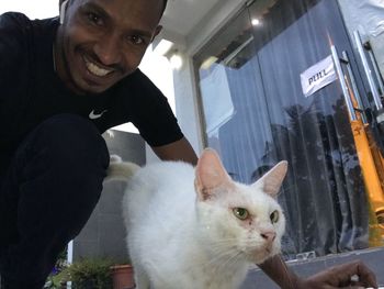 Portrait of man with cat