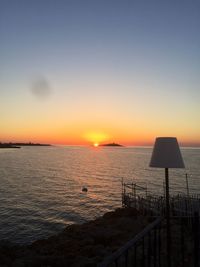 Scenic view of sea against clear sky during sunset