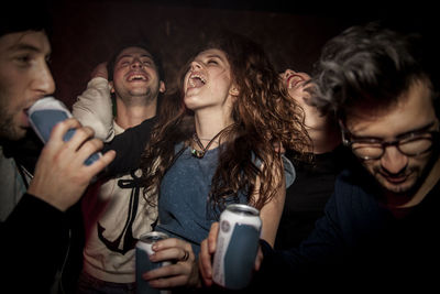 Young people enjoying music concert at night