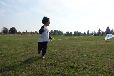 Full length of woman running on field