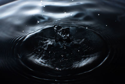 High angle view of drop falling in water