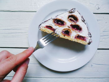 Midsection of person holding ice cream in plate