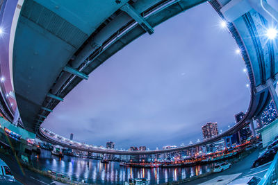 Low angle view of bridge and buildings against sky