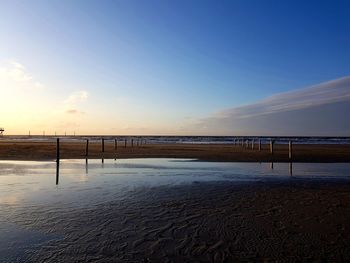 Scenic view of beach against sky during sunset