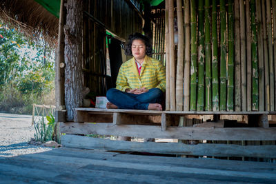 Girl meditating with eyes closed mind training in a quiet old wooden house