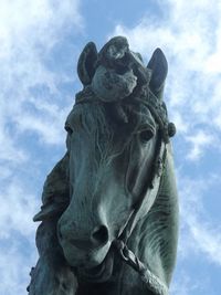 Low angle view of statue against cloudy sky