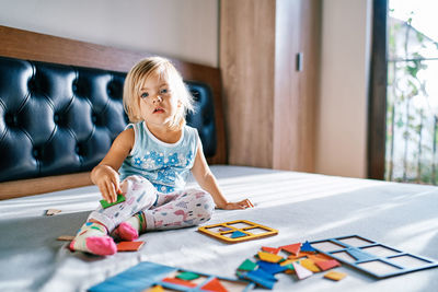 Portrait of girl playing with toy blocks at home