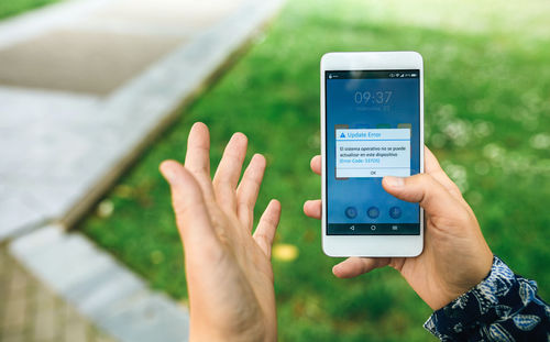 Midsection of man using mobile phone