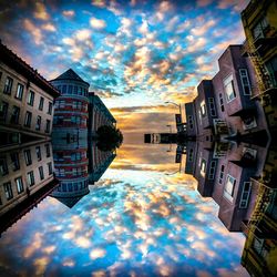 Buildings against cloudy sky at sunset