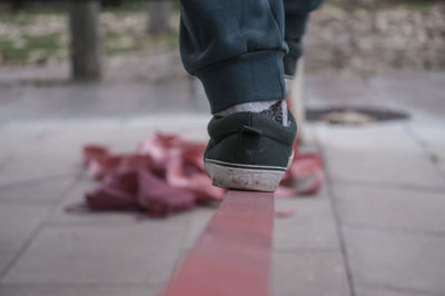 Low section of person walking on railing