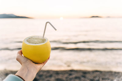 Cropped hand holding drink