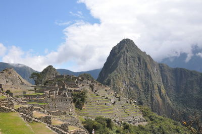 Scenic view of mountains against cloudy sky