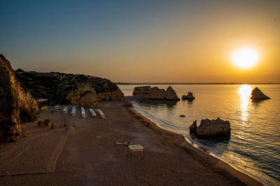 Scenic view of sea against clear sky during sunset