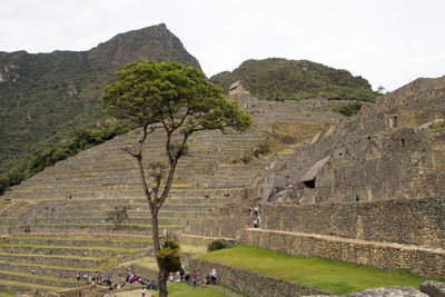 View of people on mountain against sky