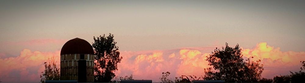 Low angle view of built structure at sunset