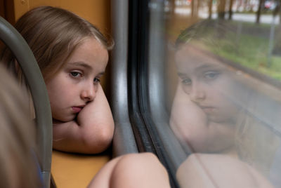 Portrait of woman looking through window