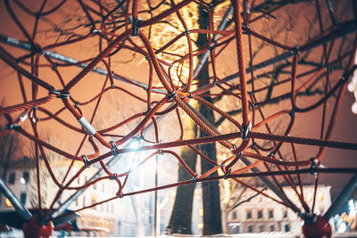 Play equipment at playground in illuminated city at night