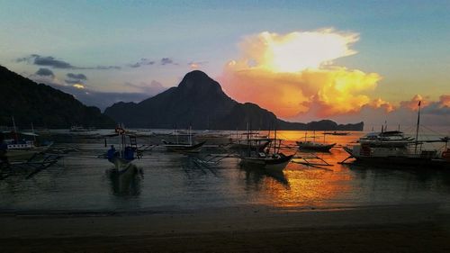 Sailboat in sea at sunset