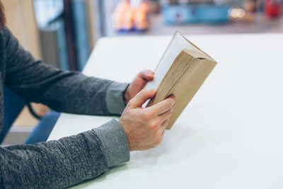 Close-up of person hand holding book