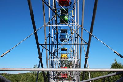 Low angle view of telephone pole against clear blue sky