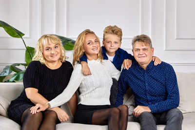 Portrait of friends sitting on sofa