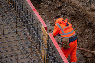 Rear view of man working at construction site