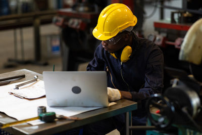 Midsection of man working in factory