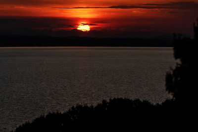 Scenic view of sea against romantic sky at sunset