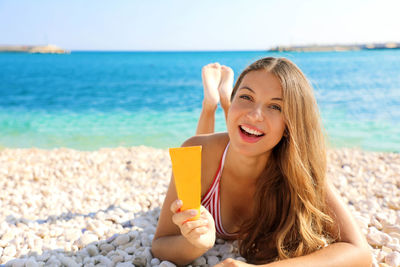 Portrait of smiling young woman on beach