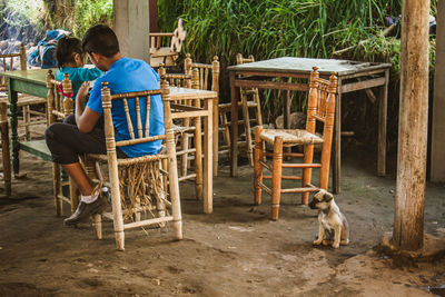 Children and pet waiting for lunch in rural restaurant 
