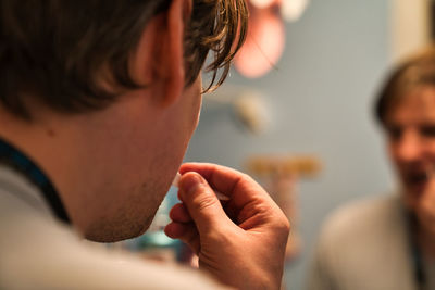 A scene of a white man uses floss