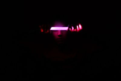 Close-up of illuminated lighting equipment in darkroom