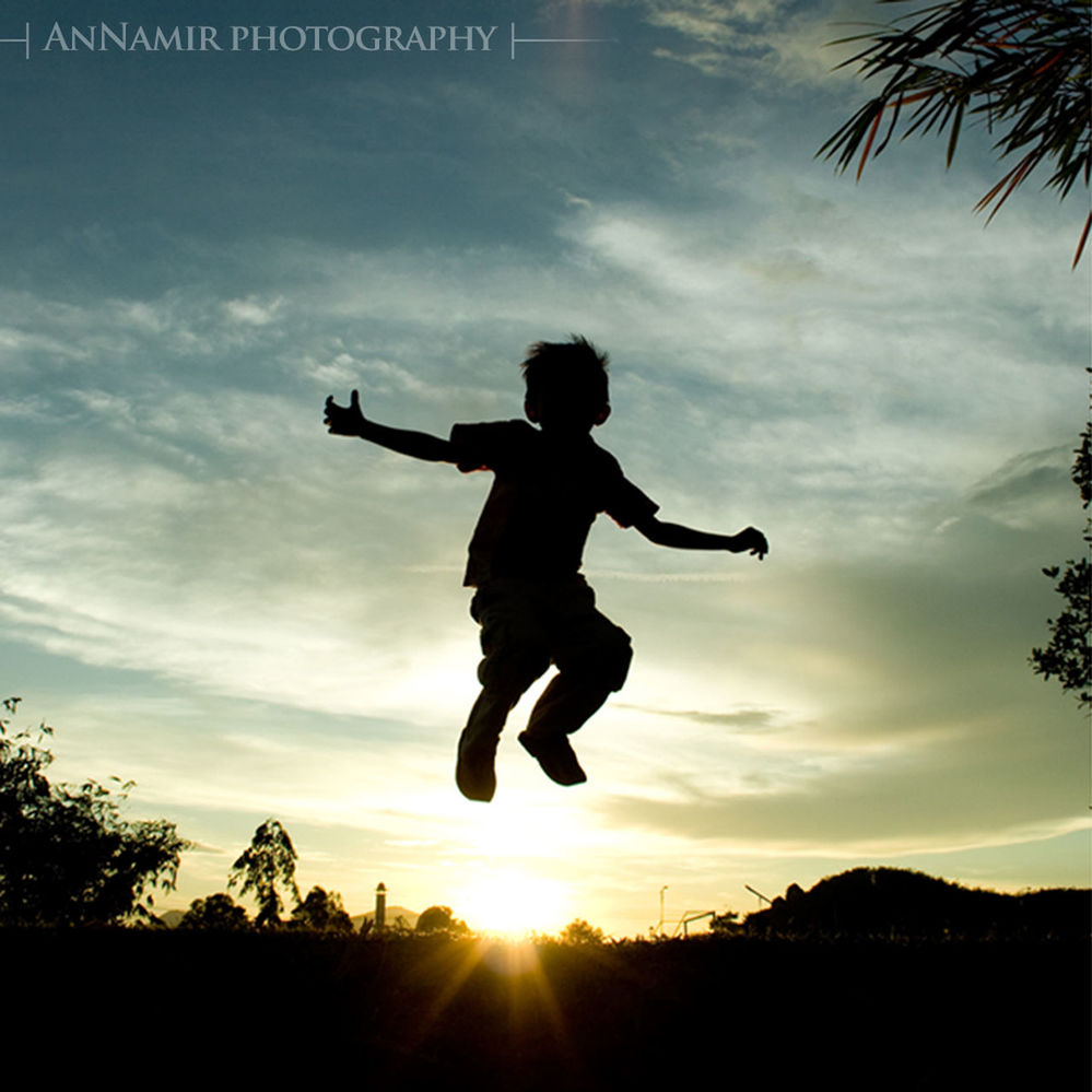 full length, lifestyles, silhouette, leisure activity, sunset, sky, sun, cloud - sky, sunlight, men, standing, tree, sunbeam, childhood, enjoyment, casual clothing, low angle view, nature