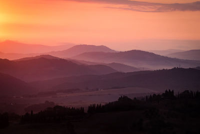 Scenic view of silhouette mountains against sky during sunset