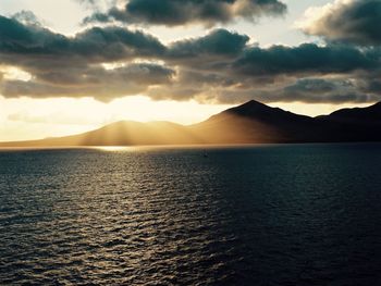 Scenic view of sea against cloudy sky