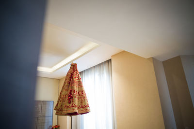 Beautiful wedding dress of indian bride hanging from roof