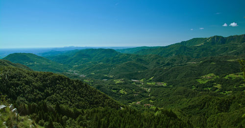 Scenic view of mountains against blue sky