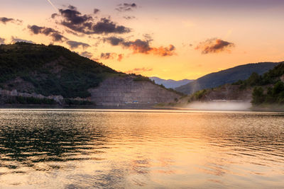 Scenic view of lake against sky during sunset