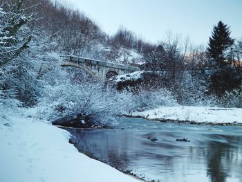 Bridge over river during winter